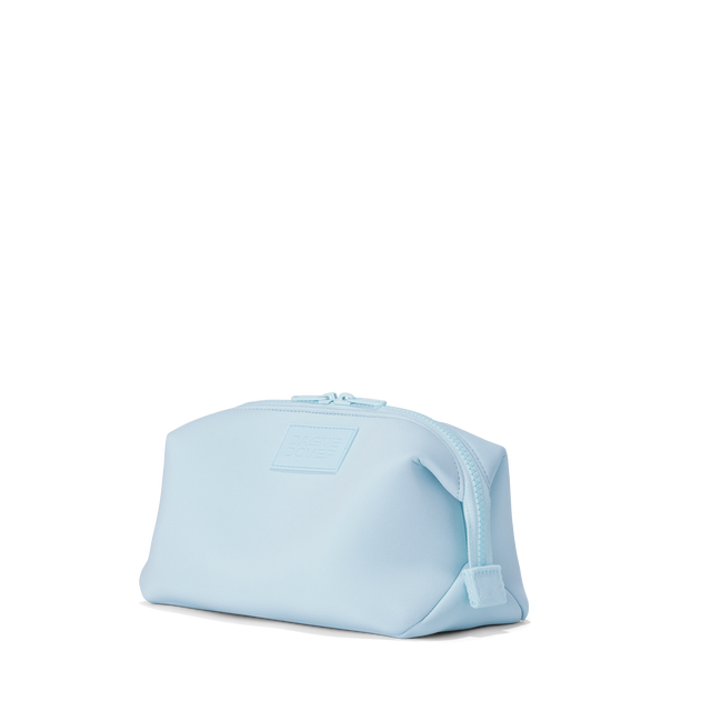 Dagne Dover Large Hunter Toiletry Bag in an airy, lighter sky blue seen from an angle.
