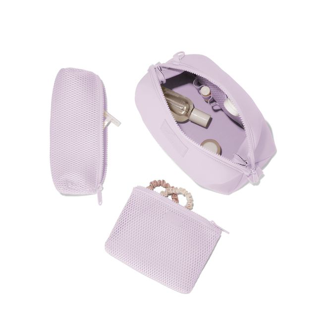 Dagne Dover Large Hunter Toiletry Bag in a soft purple with grey undertones unzipped and seen from above with the removable air mesh pouch alongside it. hover

