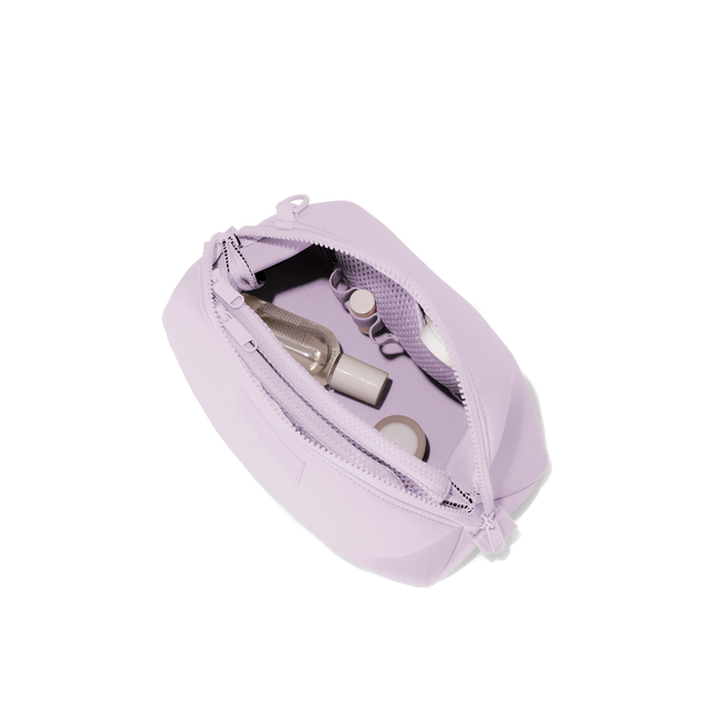 Dagne Dover Large Hunter Toiletry Bag in a soft purple with grey undertones unzipped and seen from above.
