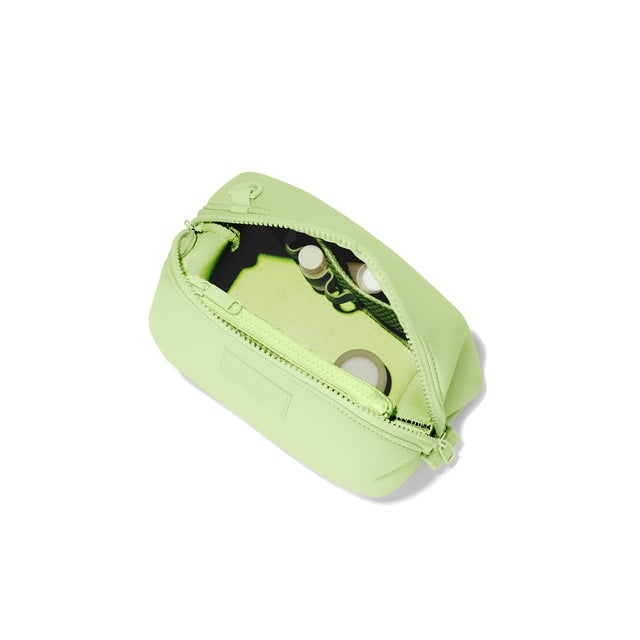 Dagne Dover Small Hunter Toiletry Bag in matcha green unzipped and seen from above.
