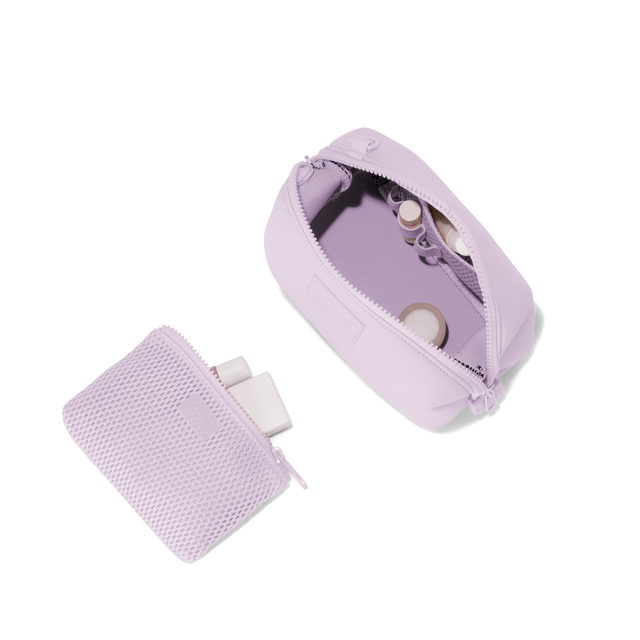 Dagne Dover small Hunter Toiletry Bag in a soft purple with grey undertones unzipped and seen from above with the removable air mesh pouch alongside it. hover
