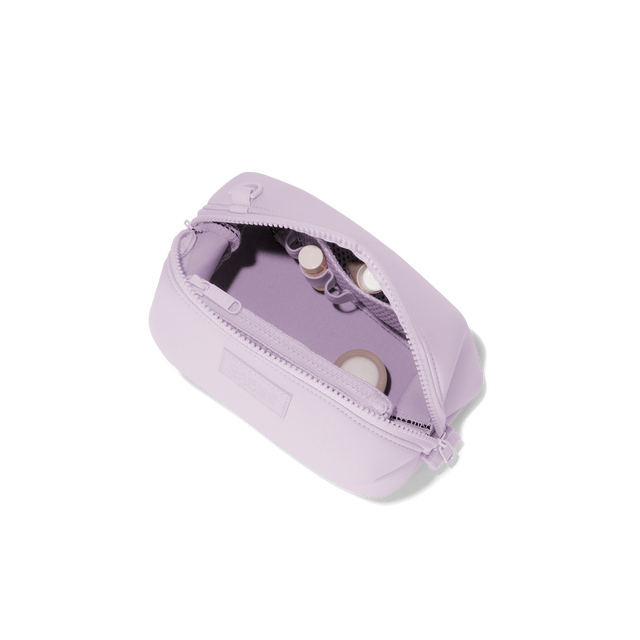 Dagne Dover small Hunter Toiletry Bag in a soft purple with grey undertones unzipped and seen from above.
