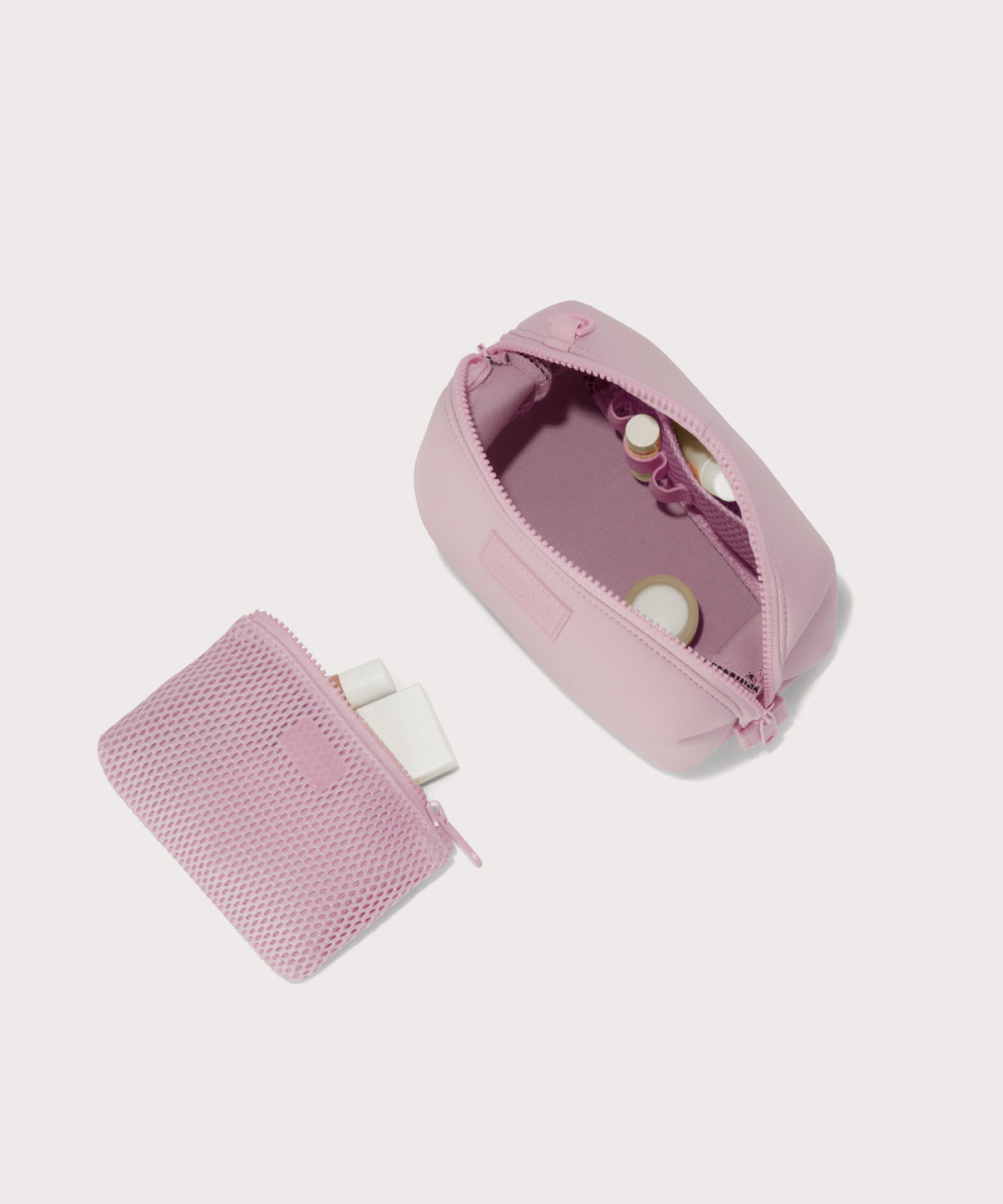 Hunter small toiletry bag in  cool, powdery pink with soft grey undertones showing exterior airmesh pouch. Top down view.
