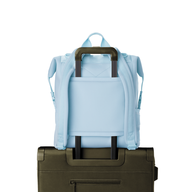 Dagne Dover Large Indi Diaper Backpack in an airy, lighter sky blue showing the neoprene luggage sleeve.
