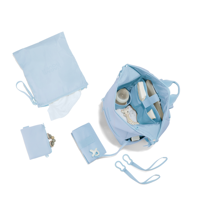 Dagne Dover Large Indi Diaper Backpack in an airy, lighter sky blue showing it's water resistant bag, interior pockets, and changing mat. hover
