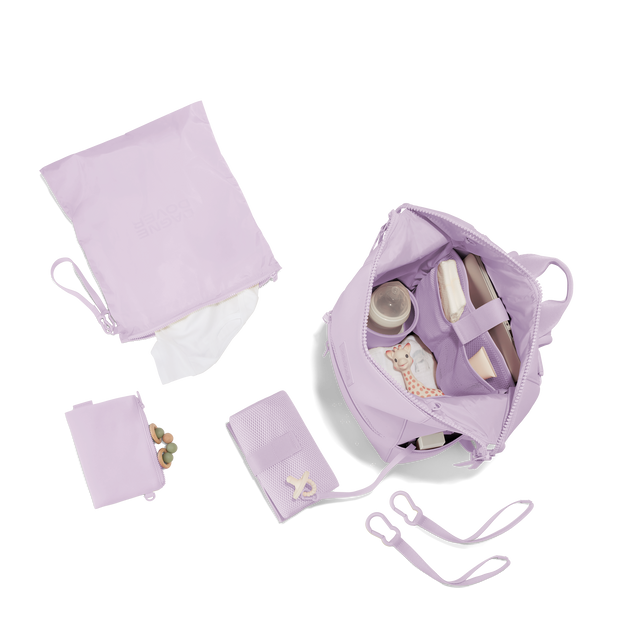 Dagne Dover Large Indi Diaper Backpack in a soft purple with grey undertones showing it's water resistant bag, interior pockets, and changing mat. Hover
