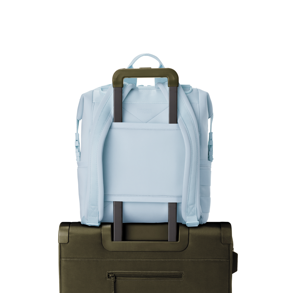 Dagne Dover medium Indi Diaper Backpack in an airy, lighter sky blue showing the neoprene luggage sleeve.
