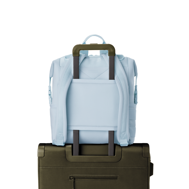 Dagne Dover medium Indi Diaper Backpack in an airy, lighter sky blue showing the neoprene luggage sleeve.
