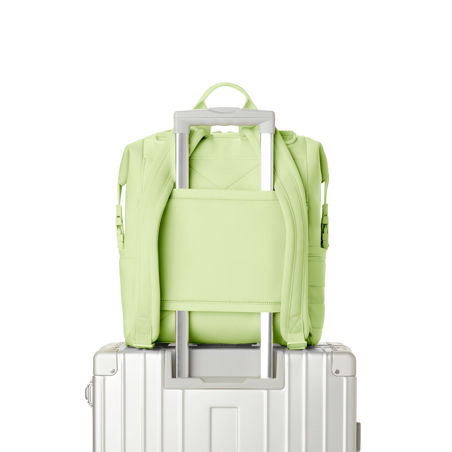 Dagne Dover Medium Indi Diaper Backpack in a vibrant, creamy green showing the neoprene luggage sleeve.