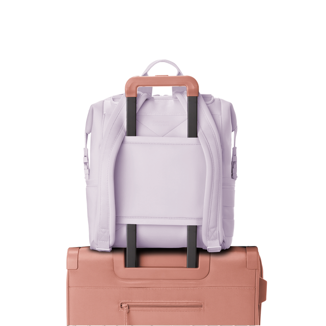Dagne Dover medium Indi Diaper Backpack in a soft purple with grey undertones showing the neoprene luggage sleeve.
