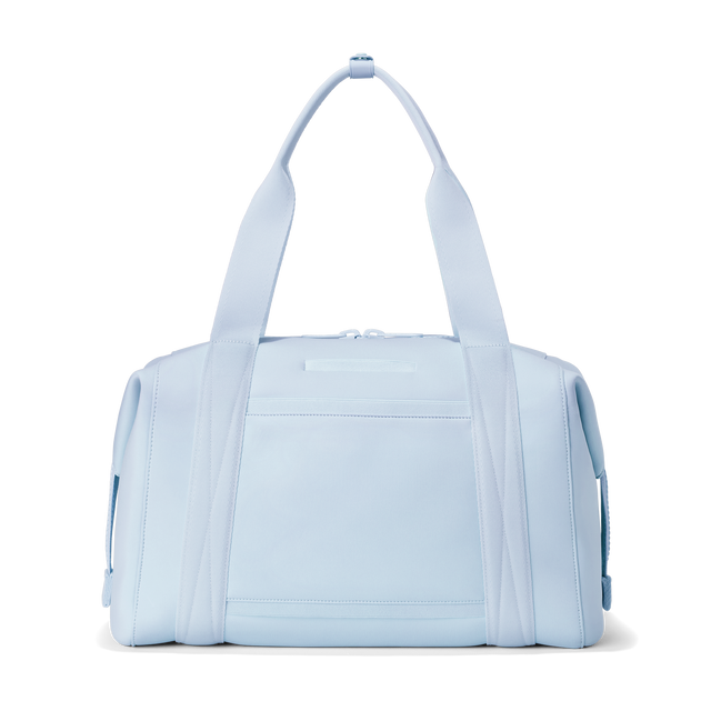 Dagne Dover large Landon Carryall in an airy, lighter sky blue seen from the back displaying an exterior phone pocket.
