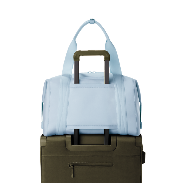 Dagne Dover large Landon Carryall in an airy, lighter sky blue displaying luggage sleeve.
