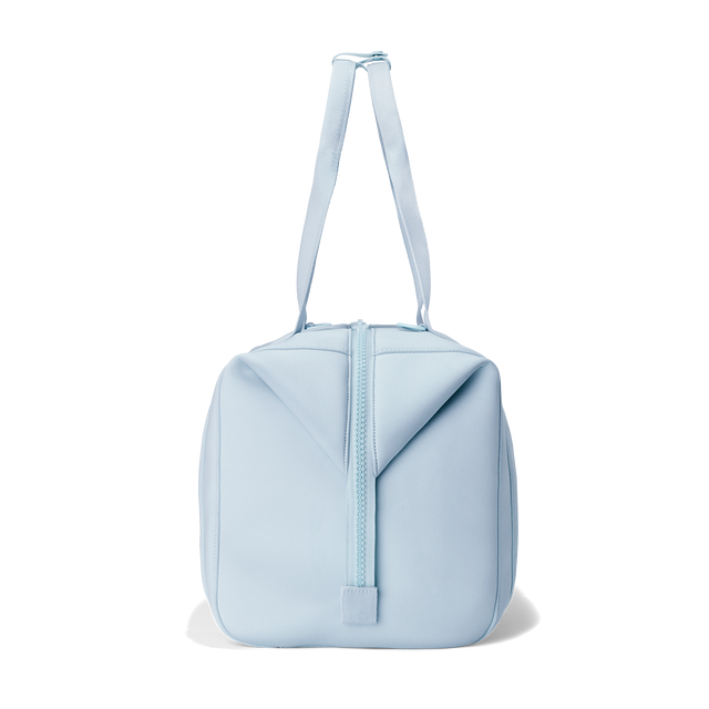 Dagne Dover large Landon Carryall in an airy, lighter sky blue, seen from the side.
