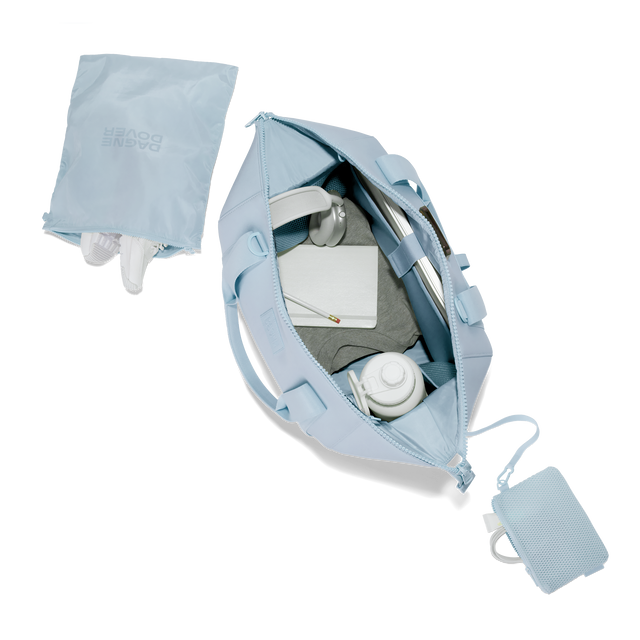 Dagne Dover large Landon Carryall in an airy, lighter sky blue unzipped, top down view. Hover
