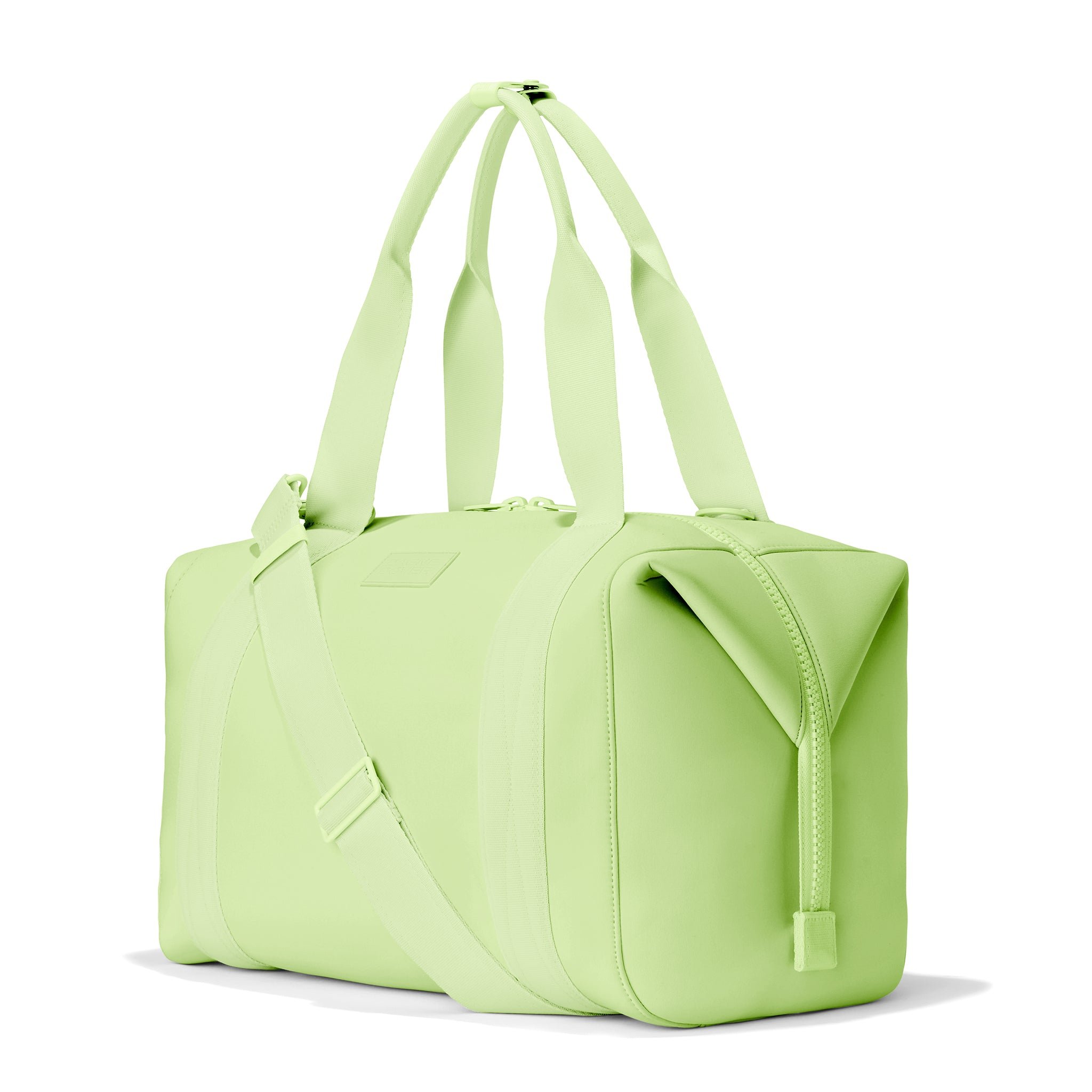 Dagne Dover Large Landon Carryall in a vibrant, creamy green, seen from an angle.