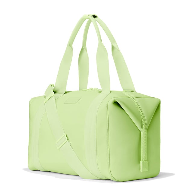 Dagne Dover Large Landon Carryall in a vibrant, creamy green, seen from an angle.