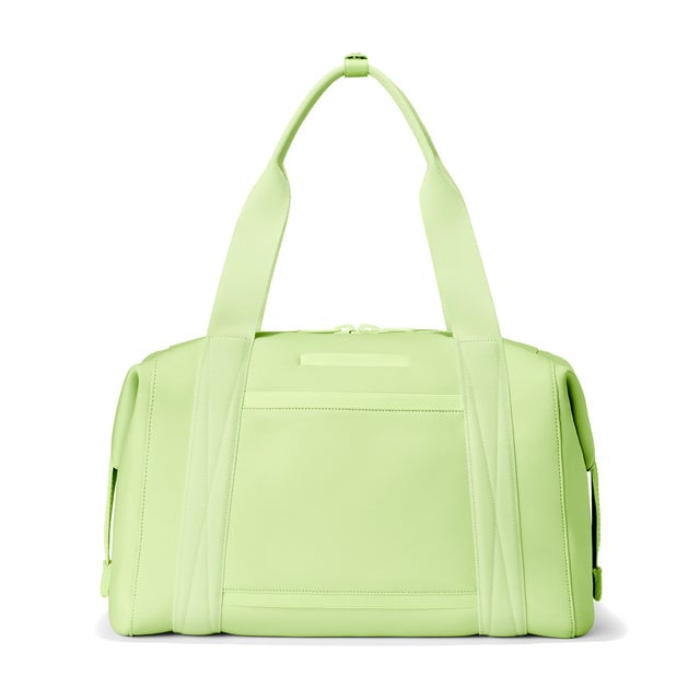 Dagne Dover Large Landon Carryall in a vibrant, creamy green, seen from the back displaying an exterior phone pocket.