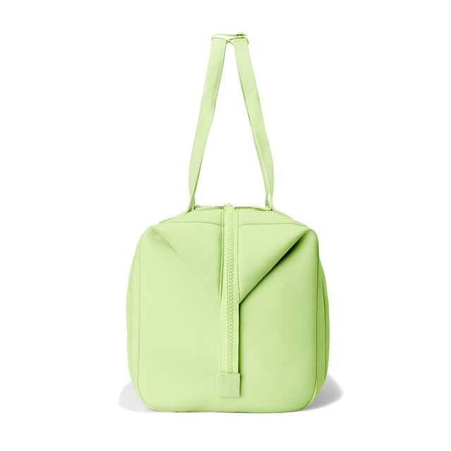 Dagne Dover Large Landon Carryall in a vibrant, creamy green, seen from the side.