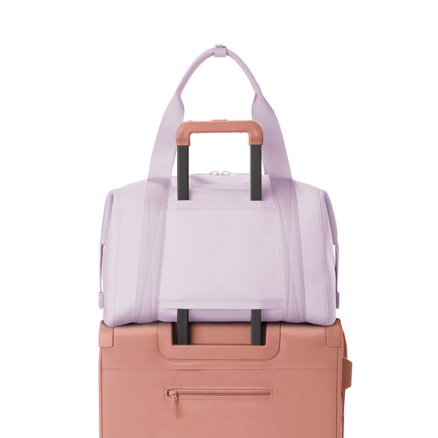 Dagne Dover large Landon Carryall in a soft purple with grey undertones displaying luggage sleeve.
