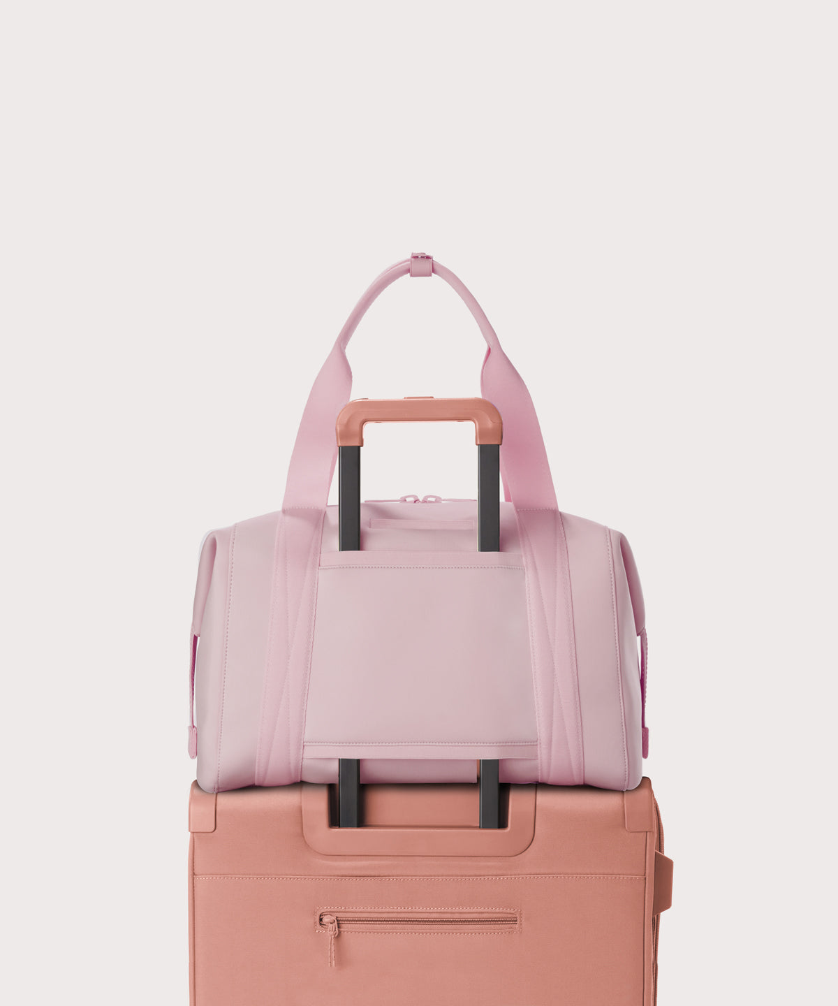  Large Landon Carryall in a cool, powdery pink with soft grey undertones displaying luggage sleeve
