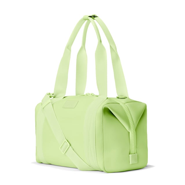 Dagne Dover Medium Landon Carryall in a vibrant, creamy green, seen from an angle.