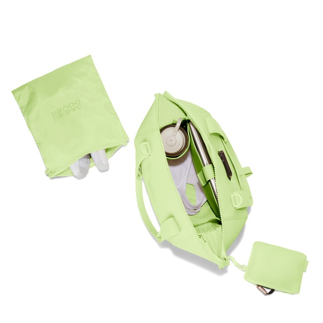 Dagne Dover Medium Landon Carryall in a vibrant, creamy green unzipped, top down view. hover