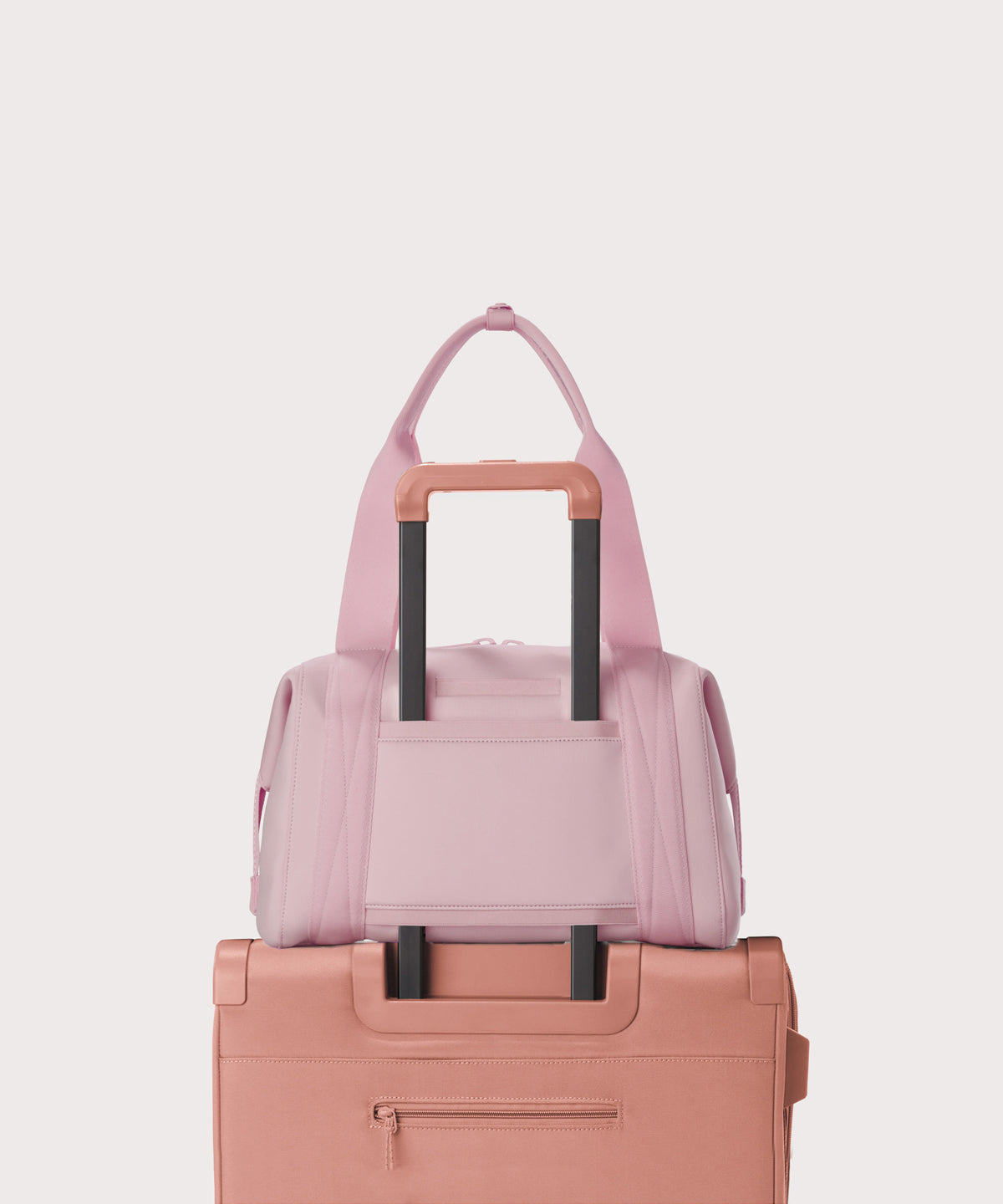  Medium Landon Carryall in a cool, powdery pink with soft grey undertones displaying luggage sleeve

