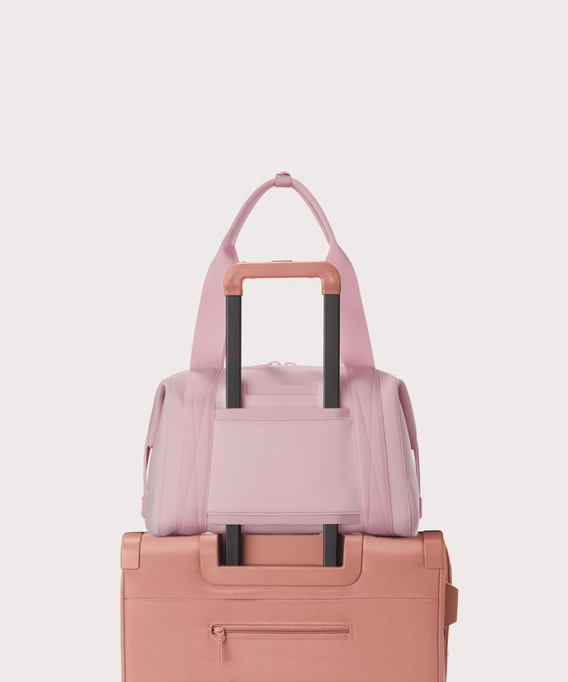  Medium Landon Carryall in a cool, powdery pink with soft grey undertones displaying luggage sleeve
