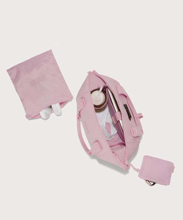  Medium Landon Carryall in a cool, powdery pink with soft grey undertones unzipped, top down view. 
