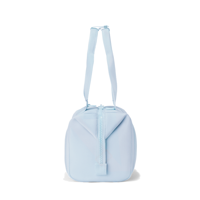 Dagne Dover small Landon Carryall in an airy, lighter sky blue seen from the side.