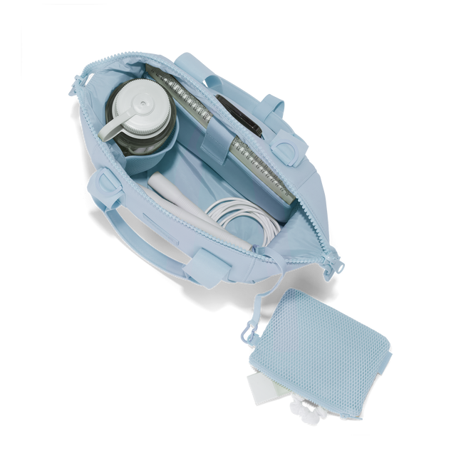Dagne Dover small Landon Carryall in an airy, lighter sky blue unzipped, top down view. Hover
