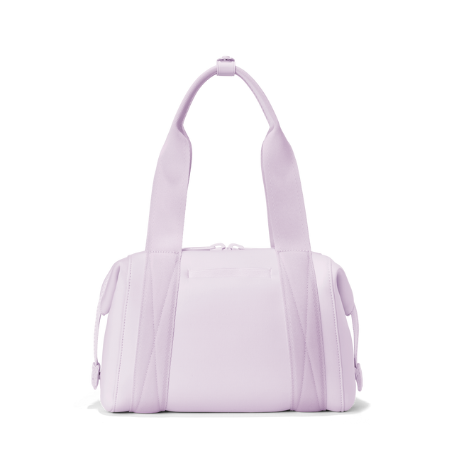 Dagne Dover small Landon Carryall in a soft purple with grey undertones seen from the back displaying an exterior phone pocket.
