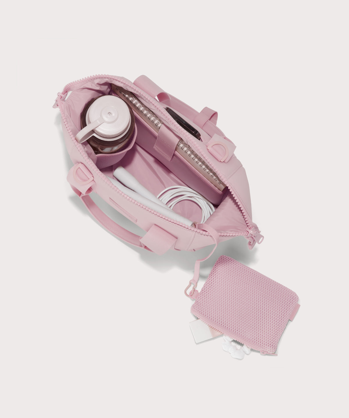  Small Landon Carryall in a cool, powdery pink with soft grey undertones unzipped, top down view. 
