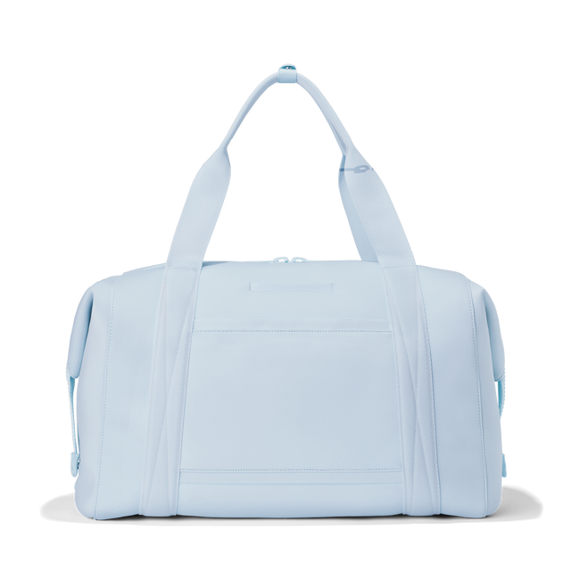 Dagne Dover extra large Landon Carryall in an airy, lighter sky blue seen from the back displaying an exterior phone pocket.