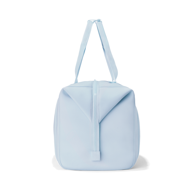 Dagne Dover extra large Landon Carryall in an airy, lighter sky blue, seen from the side.
