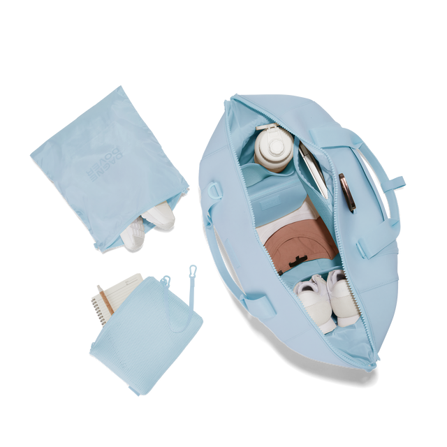 Dagne Dover extra large Landon Carryall in an airy, lighter sky blue unzipped, top down view. Hover
