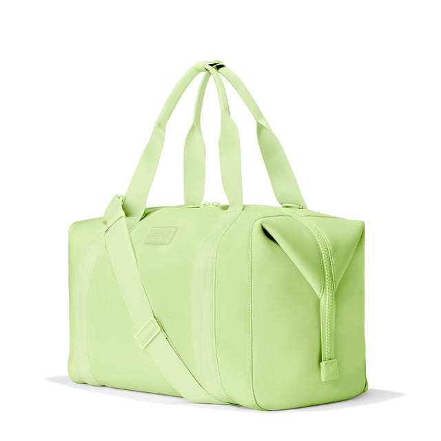 Dagne Dover Extra Large Landon Carryall in a vibrant, creamy green, seen from an angle.