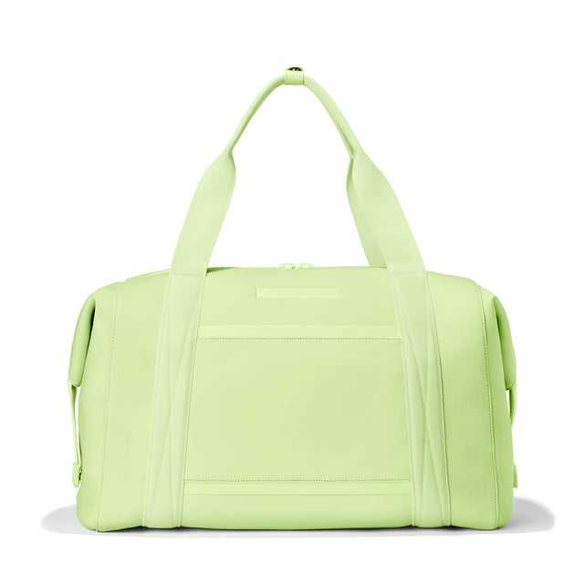 Dagne Dover Extra Large Landon Carryall in a vibrant, creamy green, seen from the back displaying an exterior phone pocket.