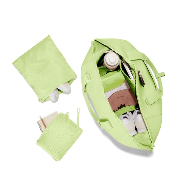 Dagne Dover Extra Large Landon Carryall in a vibrant, creamy green unzipped, top down view. hover