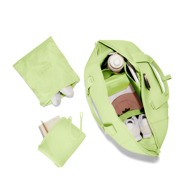 Dagne Dover Extra Large Landon Carryall in a vibrant, creamy green unzipped, top down view. hover