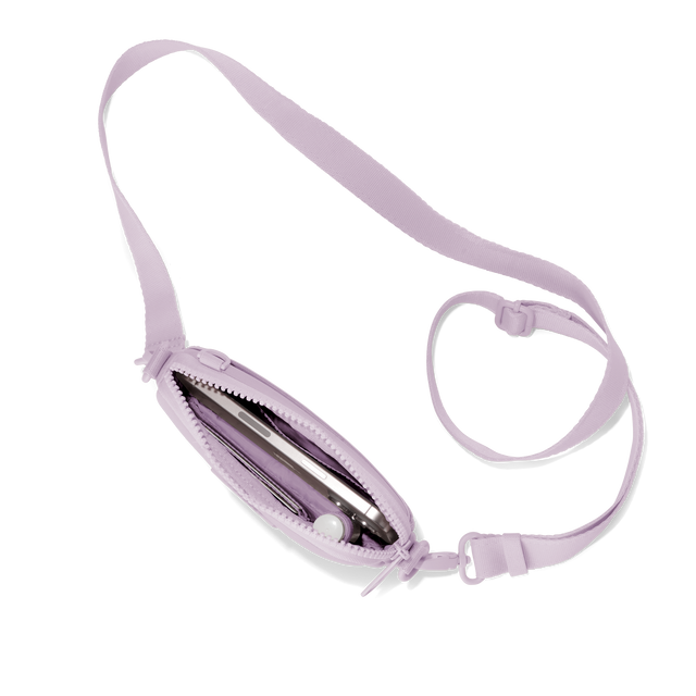 Dagne Dover Mara Phone Sling unzipped in a soft purple with grey undertones seen from above, exposing the interior card slots. hover
