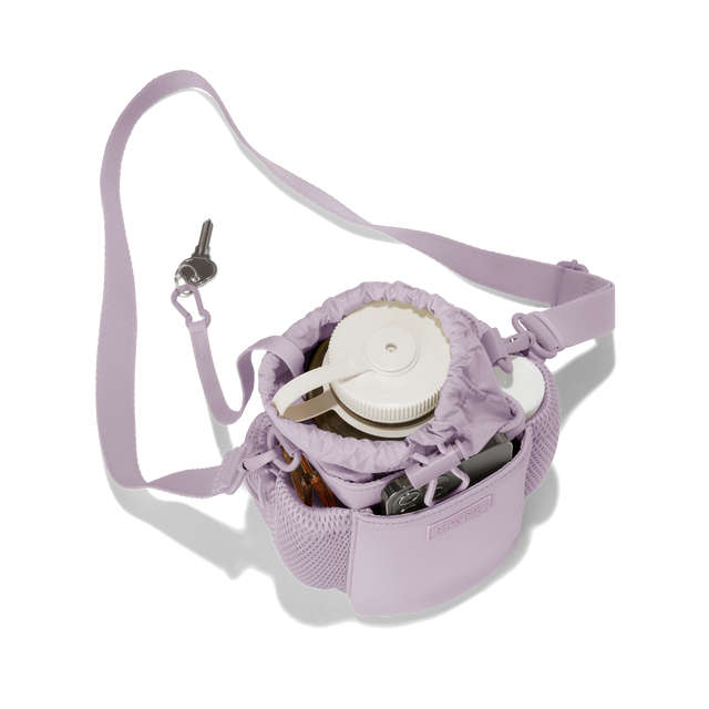 Dagne Dover Sloan Water Bottle Sling in a soft purple with grey undertones seen from above containing a water bottle and accessories. hover
