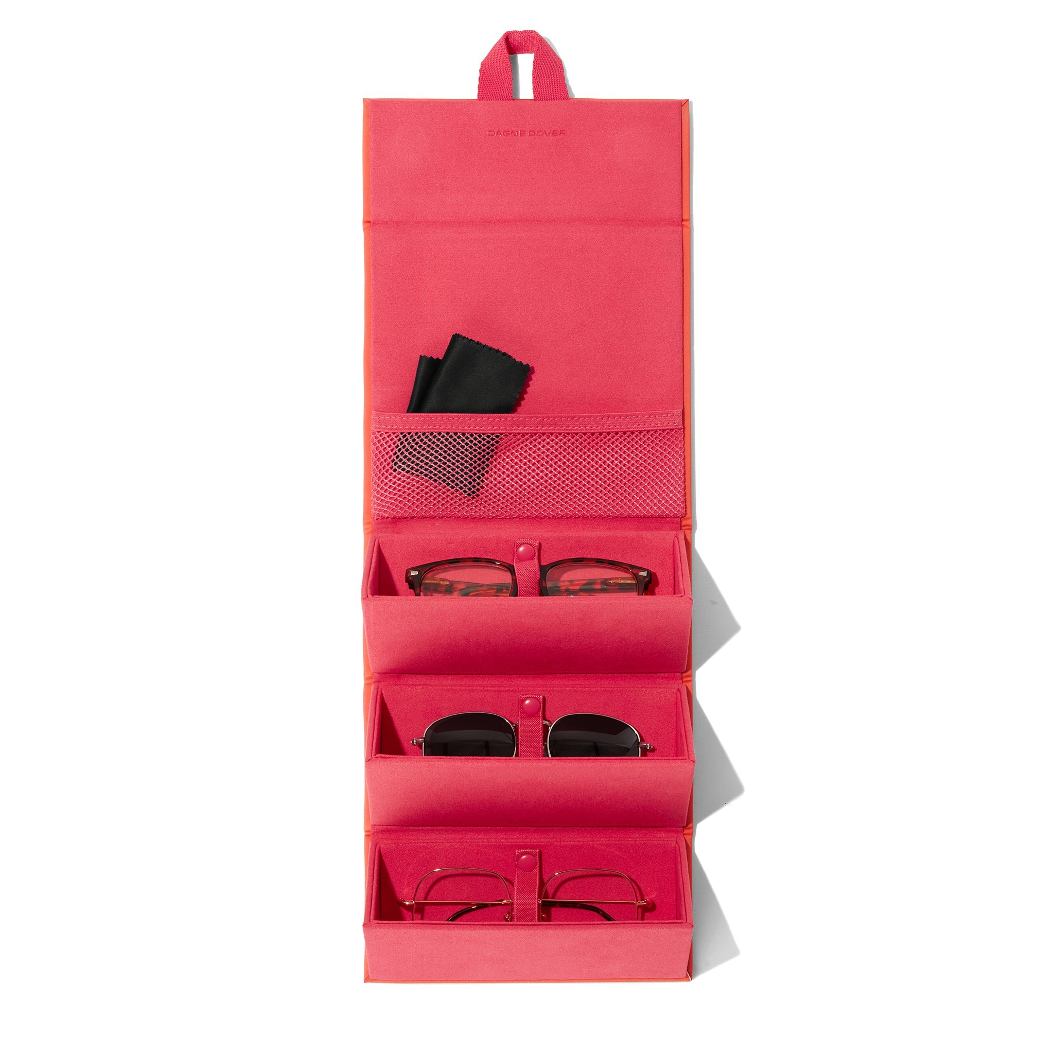 Dagne Dover Remi foldable glasses holder in dark a sun-bleached novelty treatment with fruit punch and pops of airbrushed orange hung up and holding glasses. hover