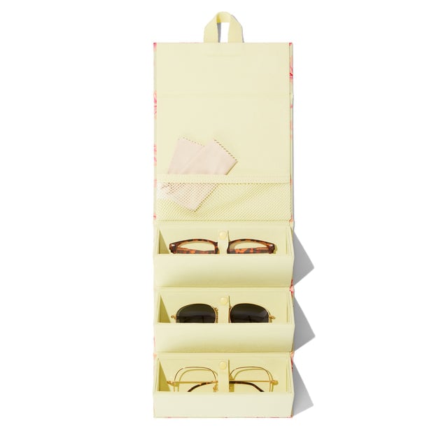 Dagne Dover Remi foldable glasses holder in dark a custom-painted hibiscus pattern hung up and holding glasses. hover