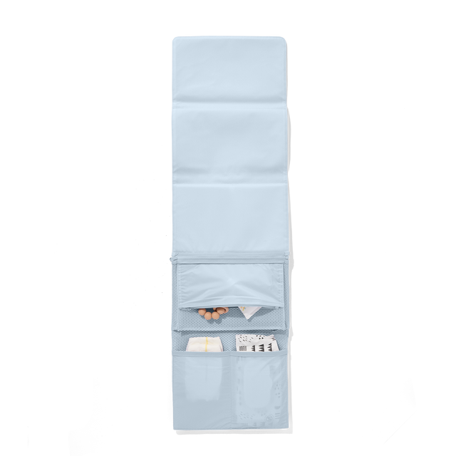 Dagne Dover Joey Changing Kit in an airy, lighter sky blue unfolded, revealing the detachable changing mat.