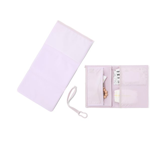 hover - Dagne Dover Joey Changing Kit in a soft purple with grey undertones unfolded, revealing the interior zipper pocket and interior slip pockets.
