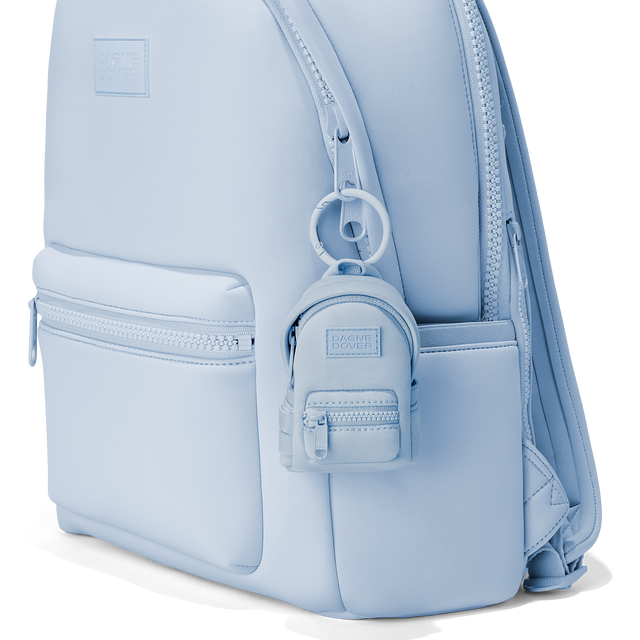 Dagne Dover Dakota Keychain in an airy, lighter sky blue clipped onto a backpack. hover
