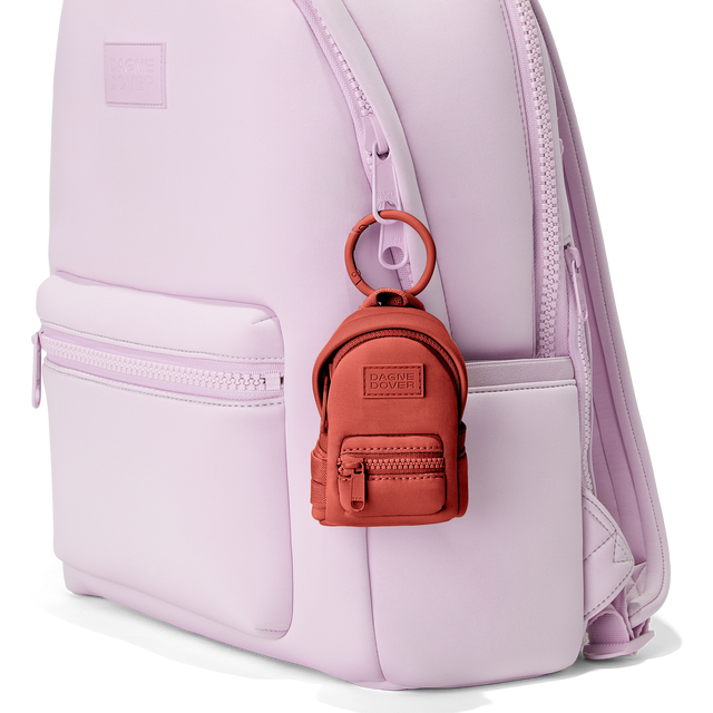 Dagne Dover Dakota Keychain in a poppy, vintage wash red clipped onto a backpack. hover