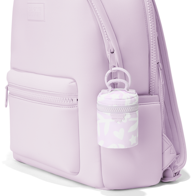 Dagne Dover mila Keychain in aa custom washed lilac and cream floral print clipped onto a backpack. hover
