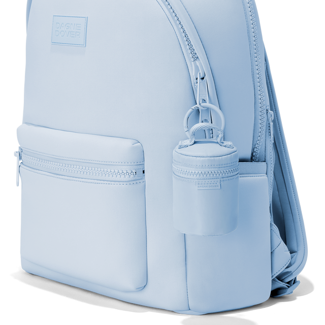 Dagne Dover Mila Keychain in an airy, lighter sky blue clipped onto a backpack. hover
